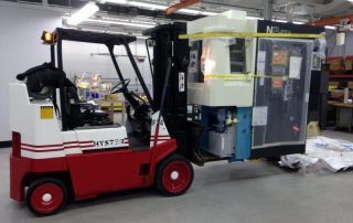 5,500 lb. Machining center uncrated, unloaded, and place in location