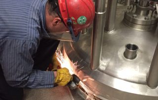 Cutting stainless shell support to remove jacketed vessel from a pharmaceutical plant