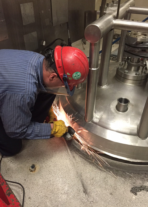 Cutting stainless shell support to remove jacketed vessel from a pharmaceutical plant