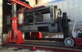 Removing 119,000 lb. clamp section of a 1,100 ton Injection Molder using 80,000 lb. Versa-Lift™ and a pair of 75 ton gantry posts on track