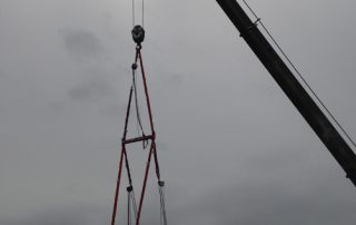 Steam Generation module rigged into Pharmaceutical plant through a roof opening shorter than the base dimension. Unit was tilted to fit through opening and leveled with the attached hoists once under roof plane