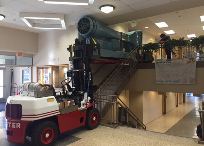 Installing lab-scale wind tunnel equipment into 2nd floor of area technical college