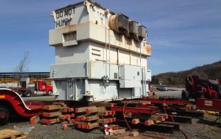 170,000 lb. transformer being loaded from ground to railcar using jacks, slider and unified hydraulic system. Scope included railcar tie-downs and later unloading from railcar to ground at destination site