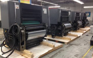 Printing press line in the staging process of being crated and packaged for international shipment. We built custom skids for each unit, secured units to the skids, double plastic wrapped, and loaded in a container.