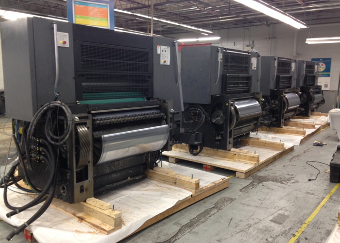 Printing press line in the staging process of being crated and packaged for international shipment. We built custom skids for each unit, secured units to the skids, double plastic wrapped, and loaded in a container.