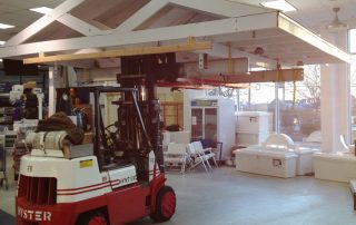 Installing kiosk inside retail marina. Note the tire socks placed over the lift truck tires to prevent tires marring marina floor