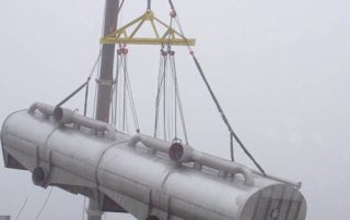 Installing 60’ long, 50,000 lb. flotation cell in recycled paper pulp mill. Note the rigging needed to equalize the load on this multi-point lift so that it could be tilted to fit through a roof opening shorter than flotation cell length